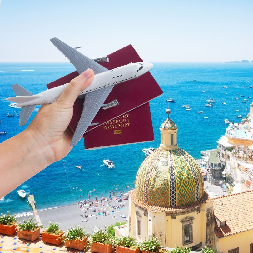 A passport held in hand against a backdrop of dreamy travel destinations
